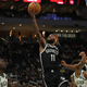 Kyrie Irving of the Brooklyn Nets is defended by Giannis Antetokounmpo of the Milwaukee Bucks during a preseason game at Fiserv Forum on October 12, 2022 in Milwaukee, Wisconsin.